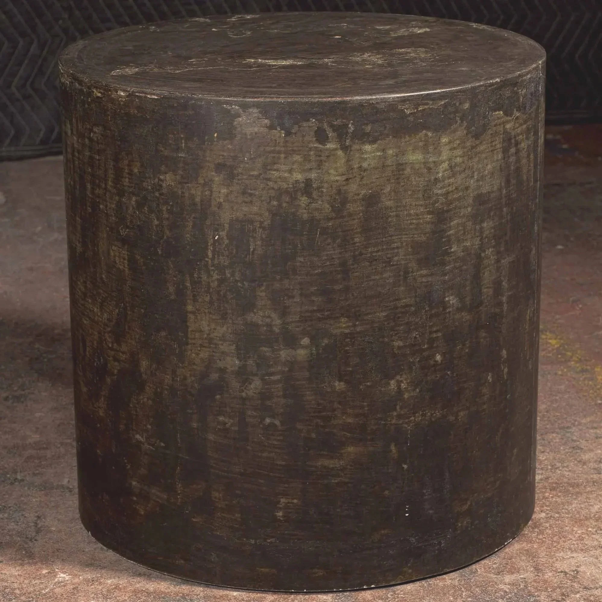 Hand-cast GFRC concrete cylinder featuring distressed metallic surface variation, aged mineral tones, and weathered industrial character.