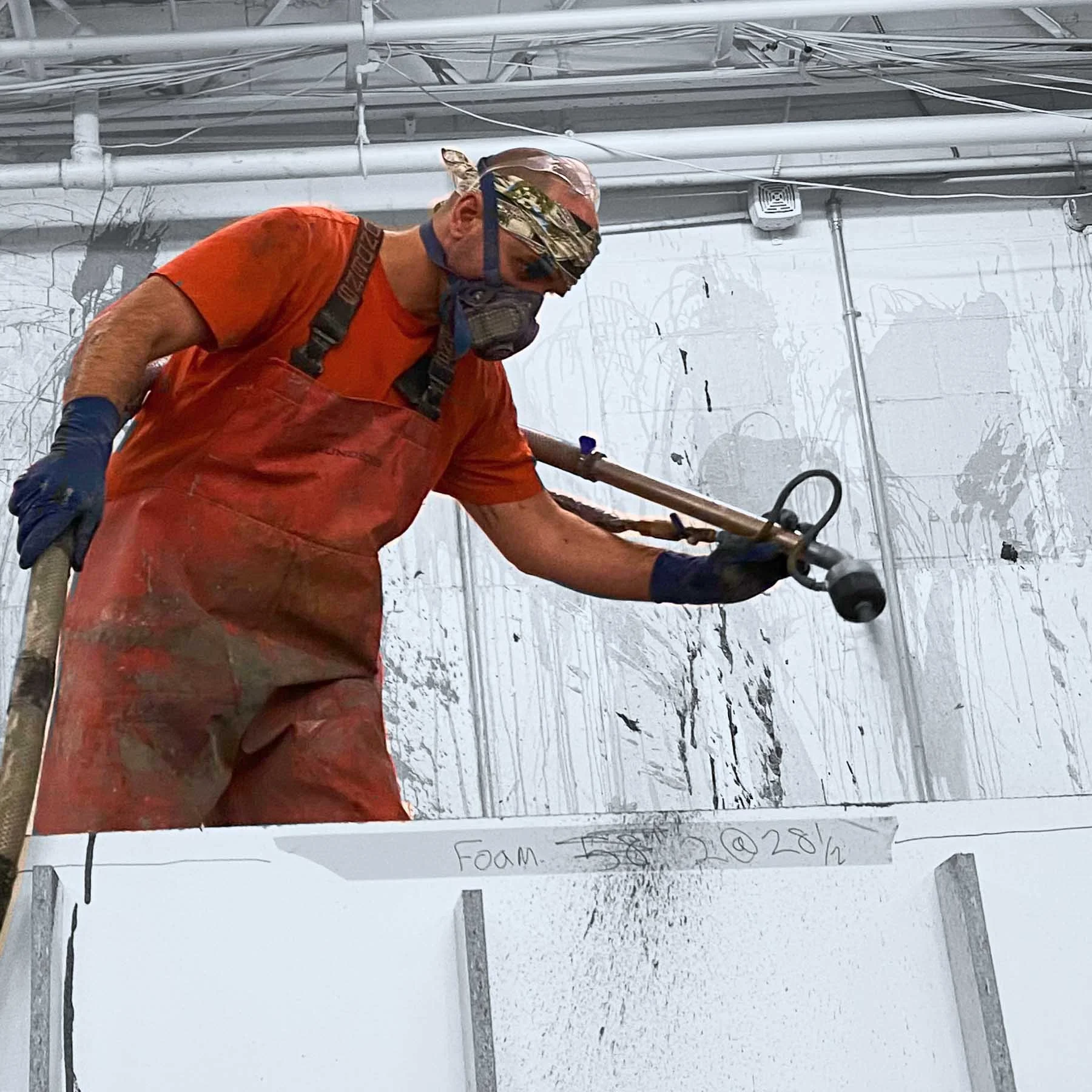 An artisan shaping foam formwork during production of the monumental LOVE public artwork.