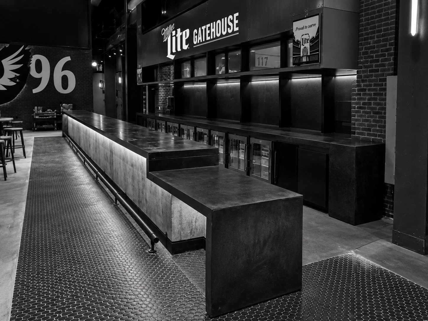 Custom black concrete bar and architectural back bar at the Miller Lite Gatehouse, M&T Bank Stadium in Baltimore, by The Concrete Anomaly.
