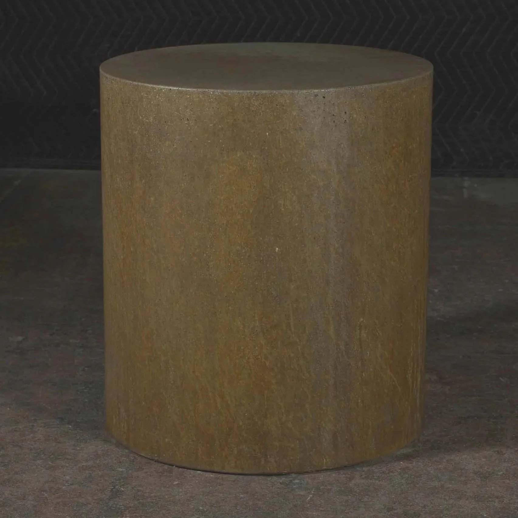 Minimal cylindrical concrete side table featuring deep rust-toned pigment and industrial oxidized metal character within line ZERO.