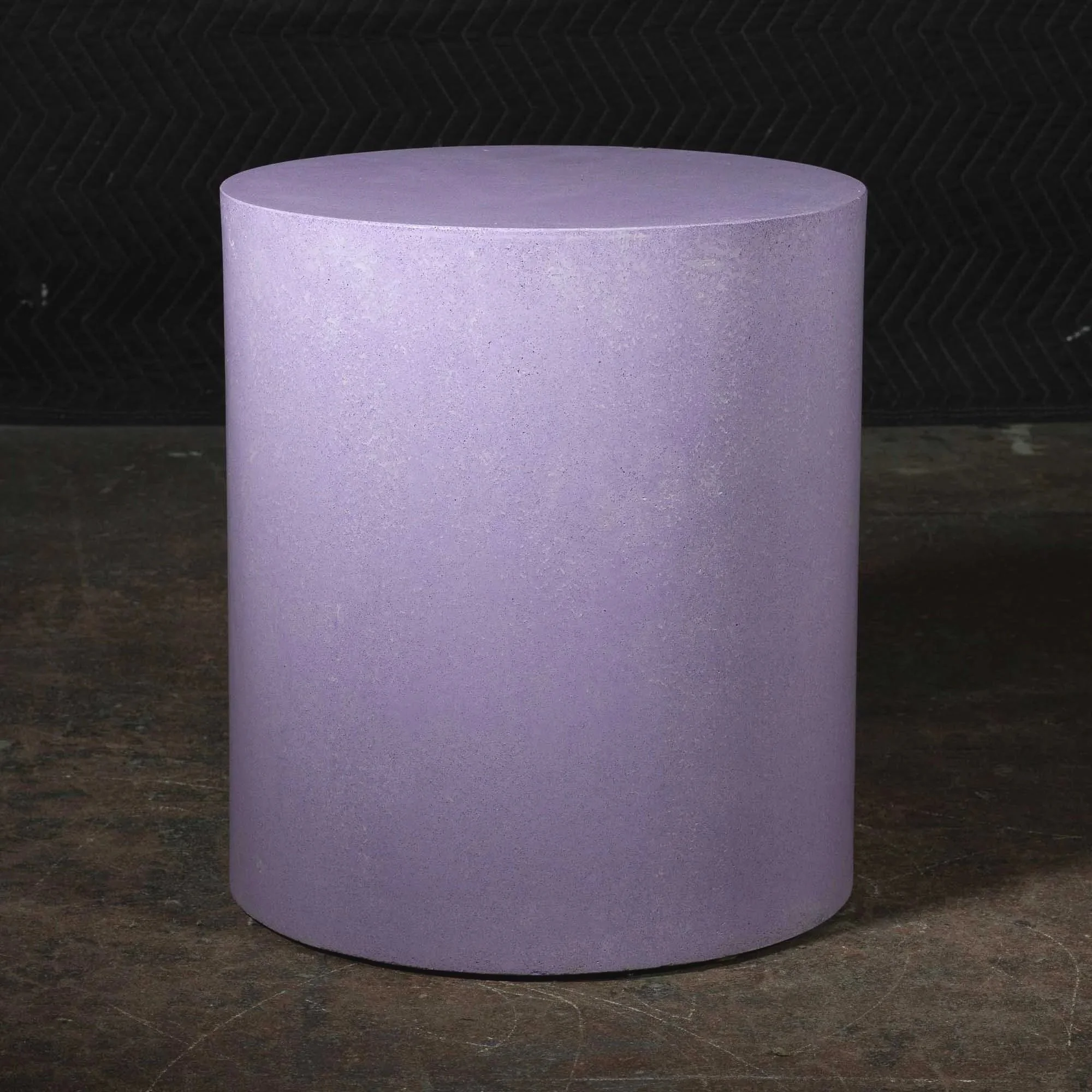 Minimal concrete side table with pale purple pigment and subtle crystalline texture inspired by light and fracture.