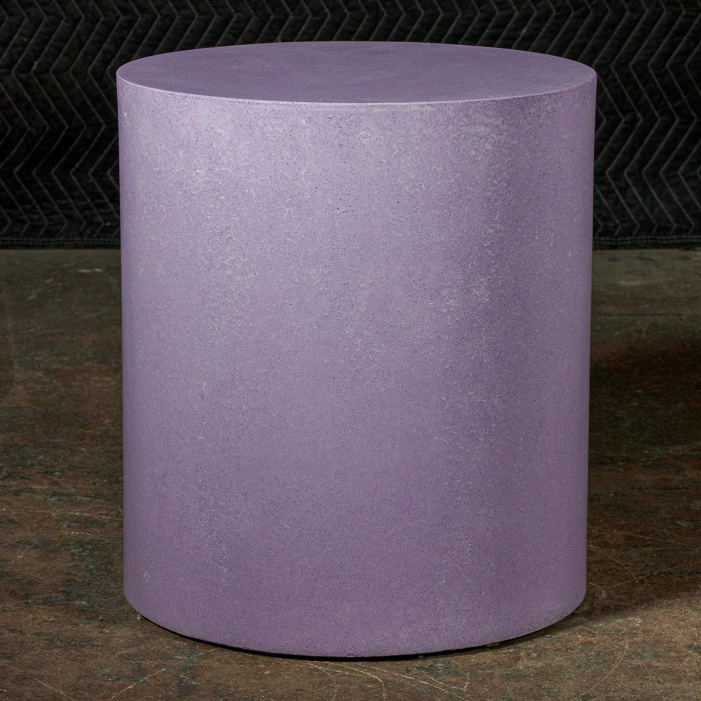 Hand-cast GFRC concrete cylinder featuring soft violet mineral tones and refined monolithic surface texture.
