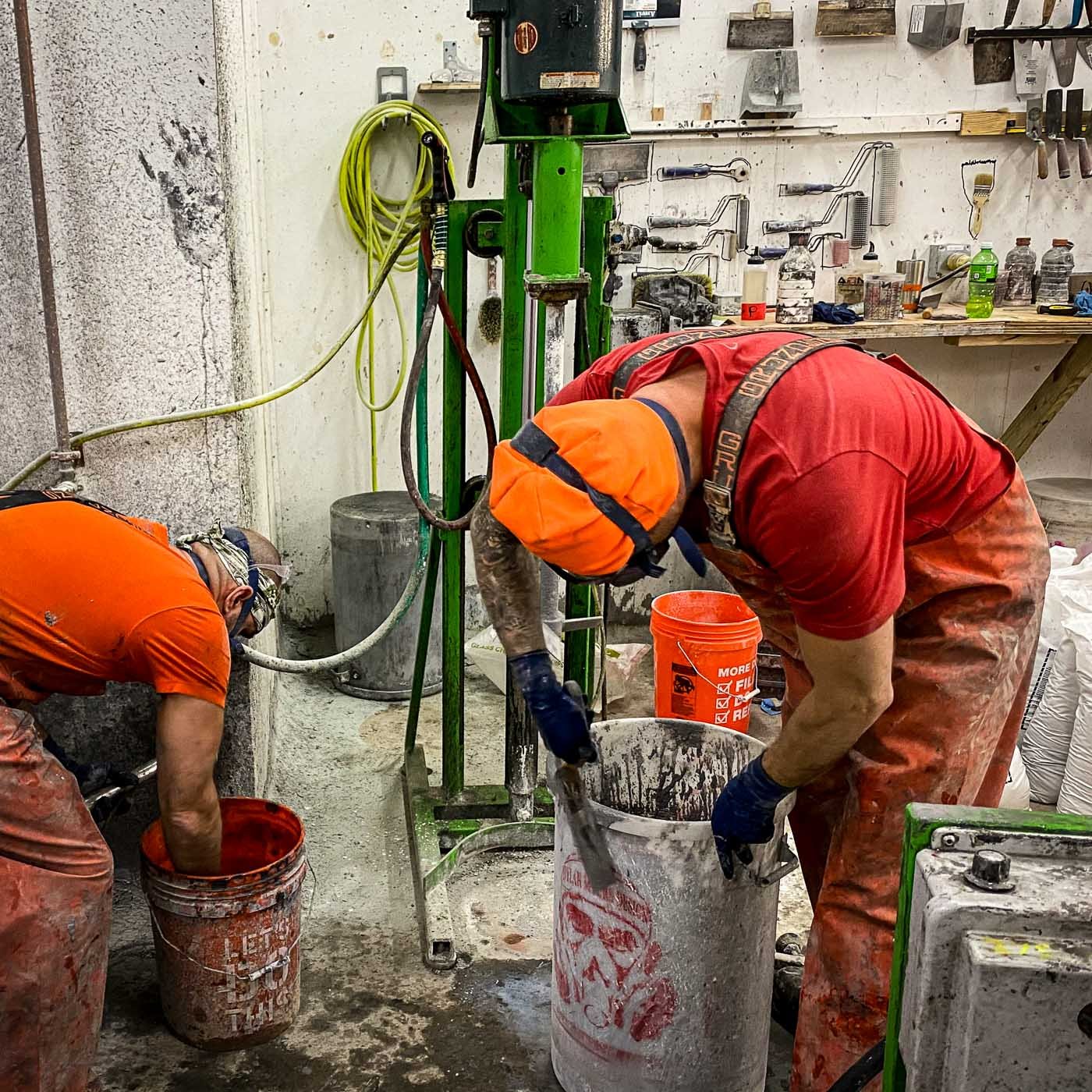 Studio artisans mixing and casting concrete components for the monumental LOVE public artwork.