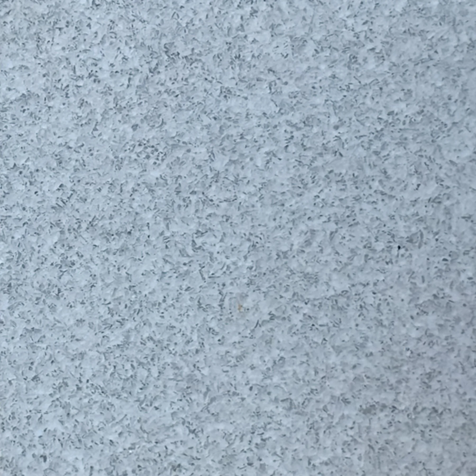 Exposed glass architectural concrete condition featuring integrated clear glass aggregate and luminous surface variation.