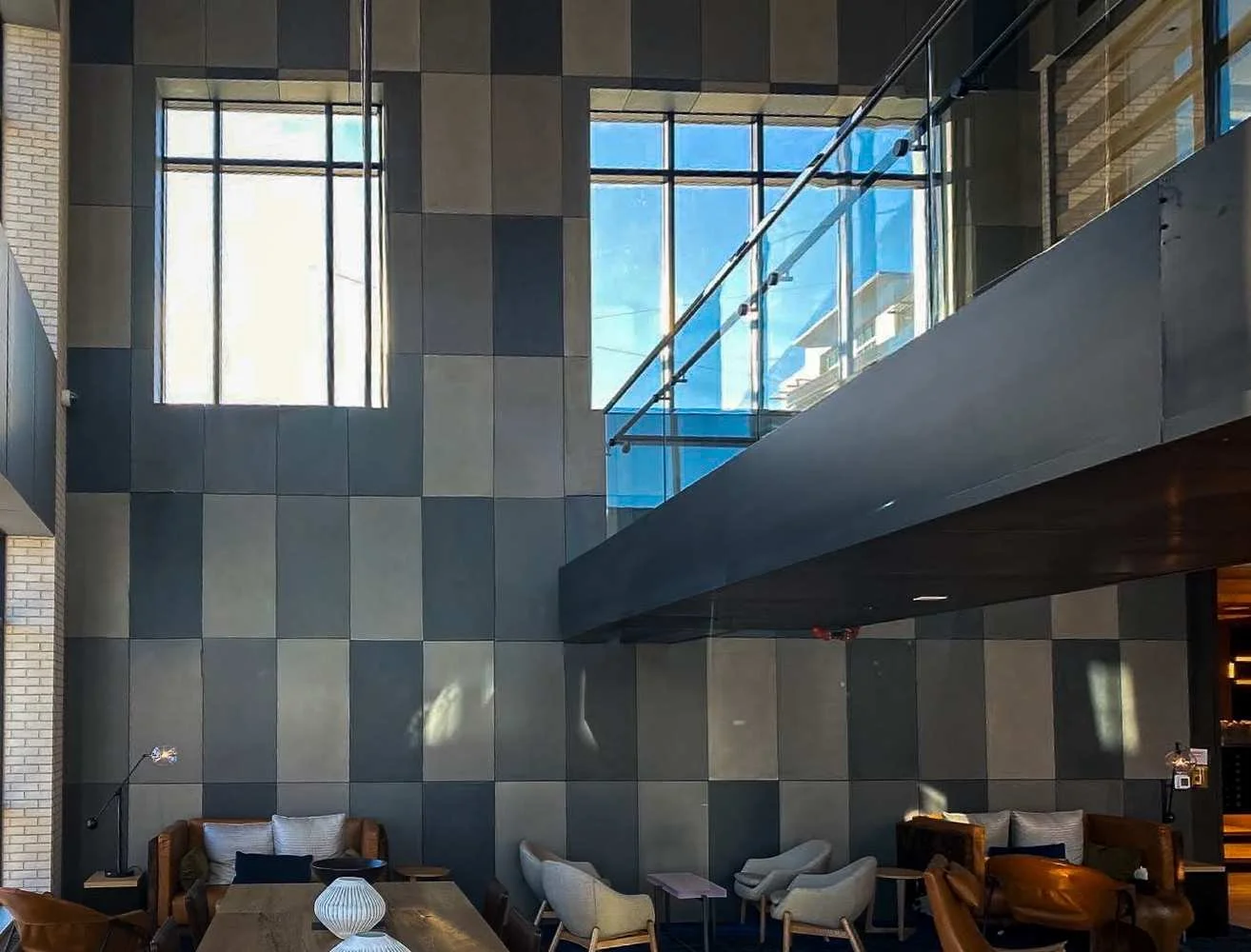 Custom concrete wall panels surrounding a glass staircase at the Quincy project.