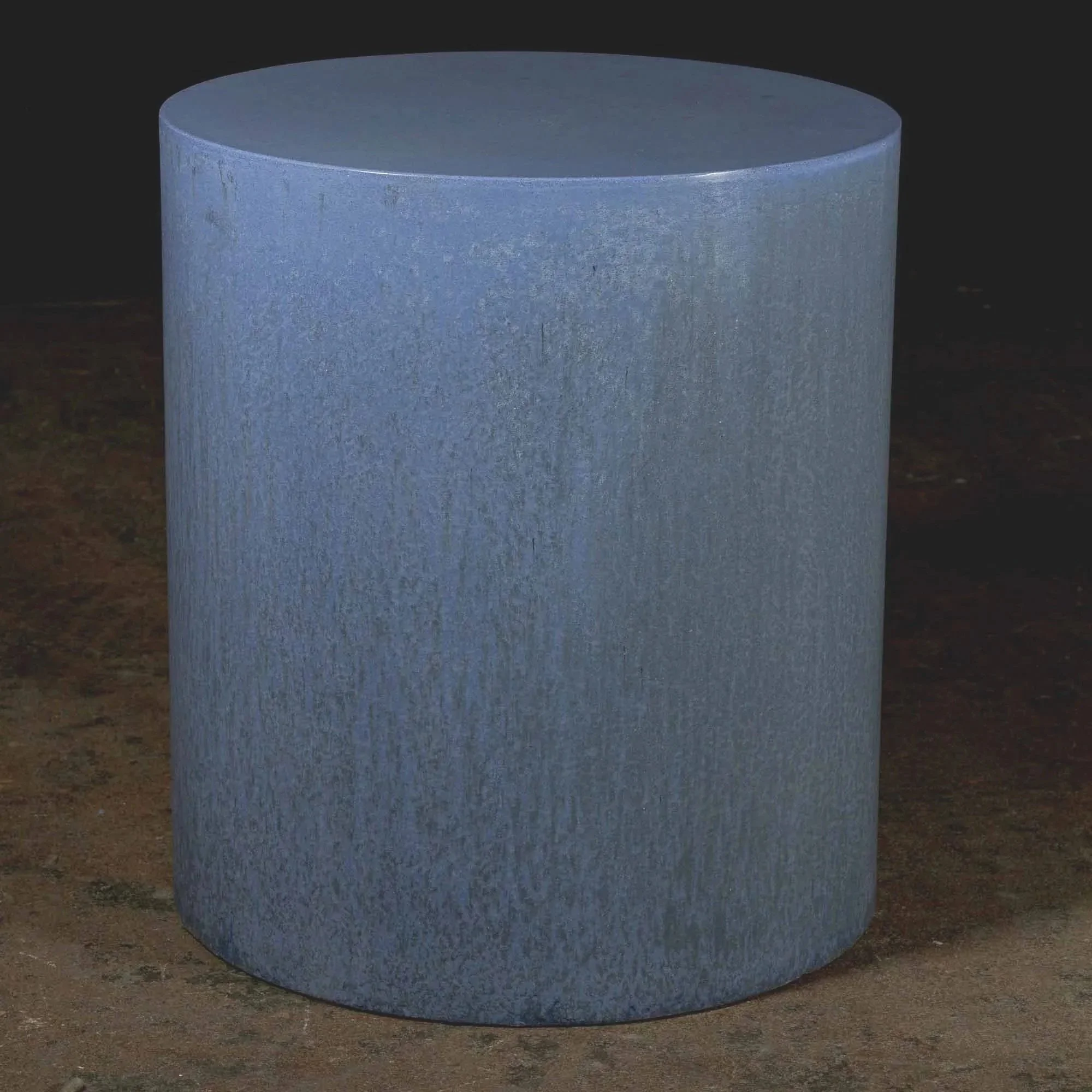 Hand-cast GFRC concrete cylinder with layered blue-grey pigment, soft tonal variation, and quiet mineral texture throughout the surface.
