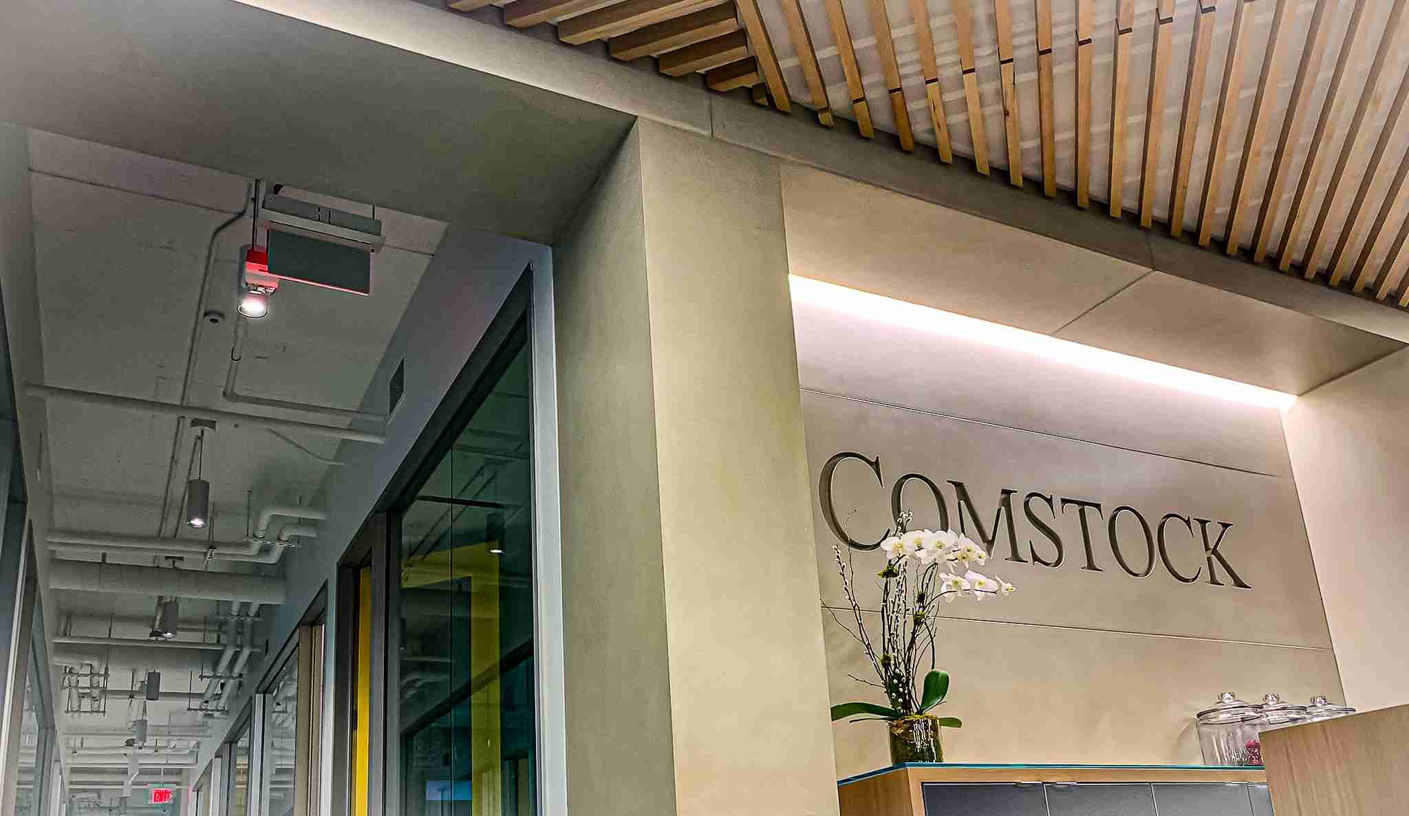 Custom cast concrete wall and column wraps forming the architectural backdrop for an integrated reception environment.