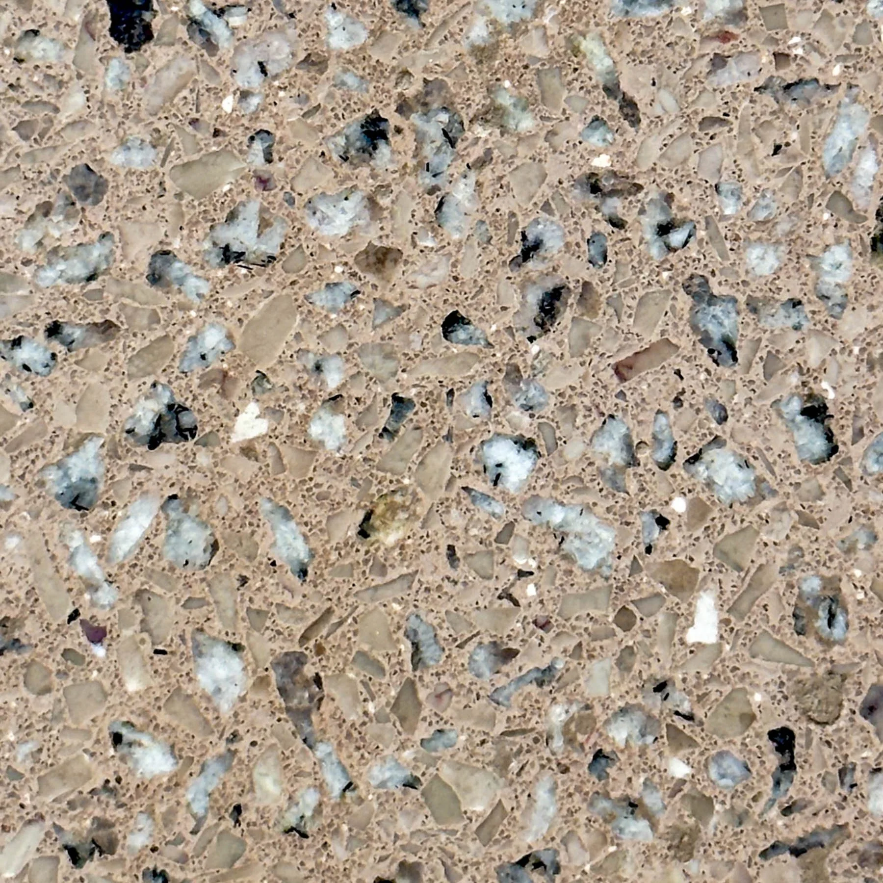 Close-up of handcrafted terrazzo concrete featuring exposed aggregate and natural mineral variation by The Concrete Anomaly.