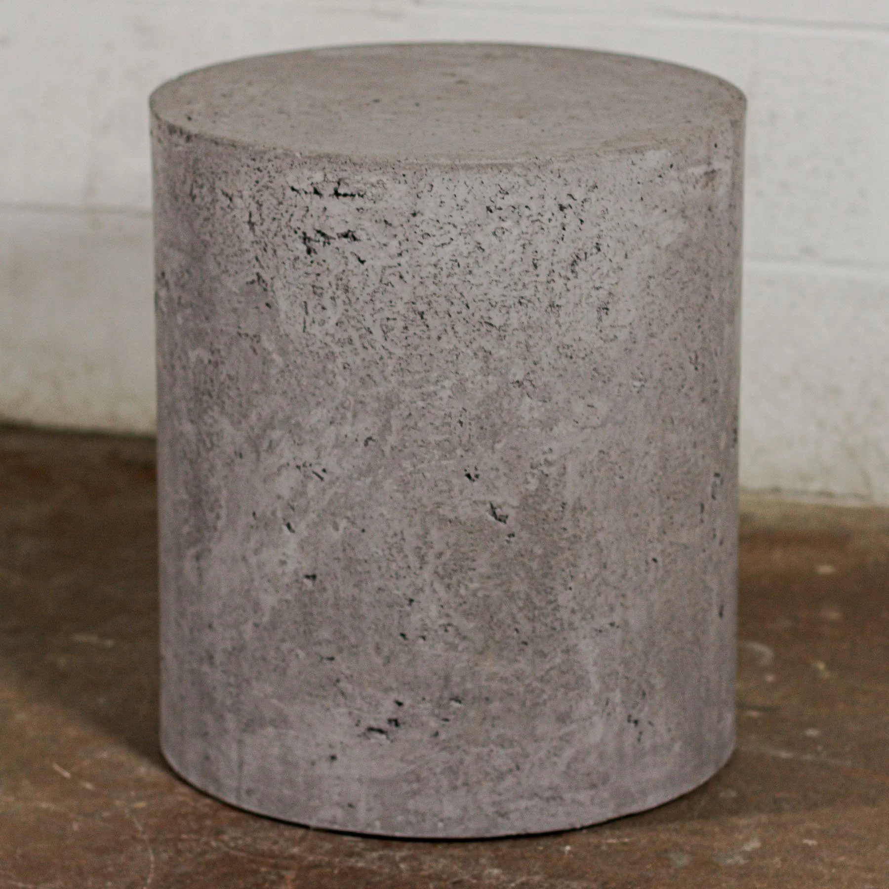 LINE RAW cylindrical concrete furnishing with soft mineral texture and monolithic form.