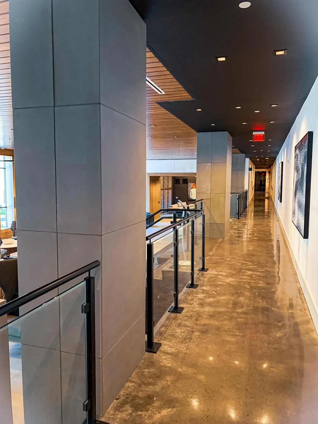 Interior corridor featuring custom cast concrete wall and column wraps with refined surface finish.