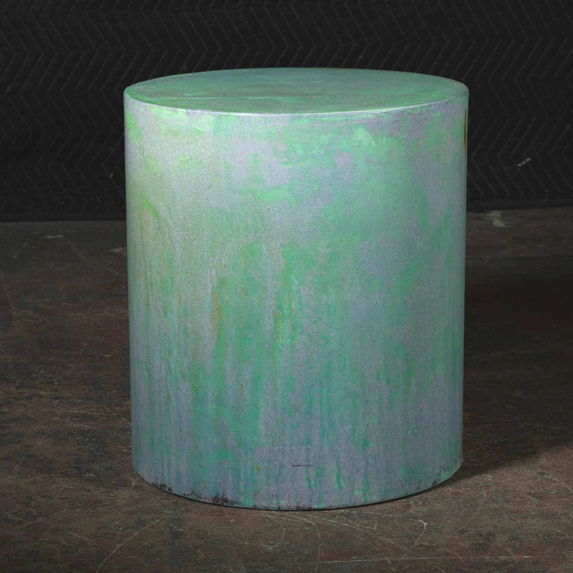 Hand-cast GFRC concrete cylinder featuring atmospheric green oxidation, vertical pigment movement, and softened architectural texture from The Concrete Anomaly.