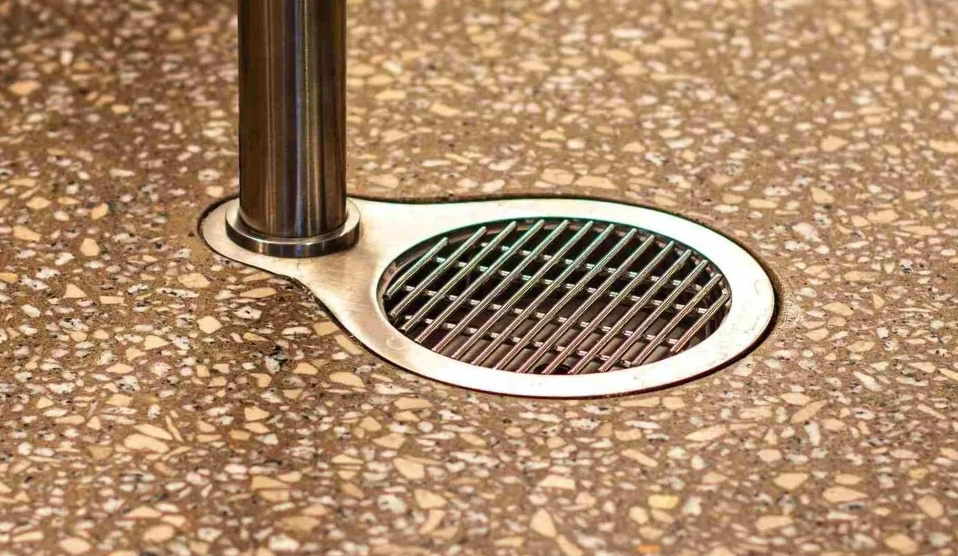 Flush integrated floor drain detail within a terrazzo architectural concrete surface fabricated by The Concrete Anomaly for the Glenmede headquarters project.