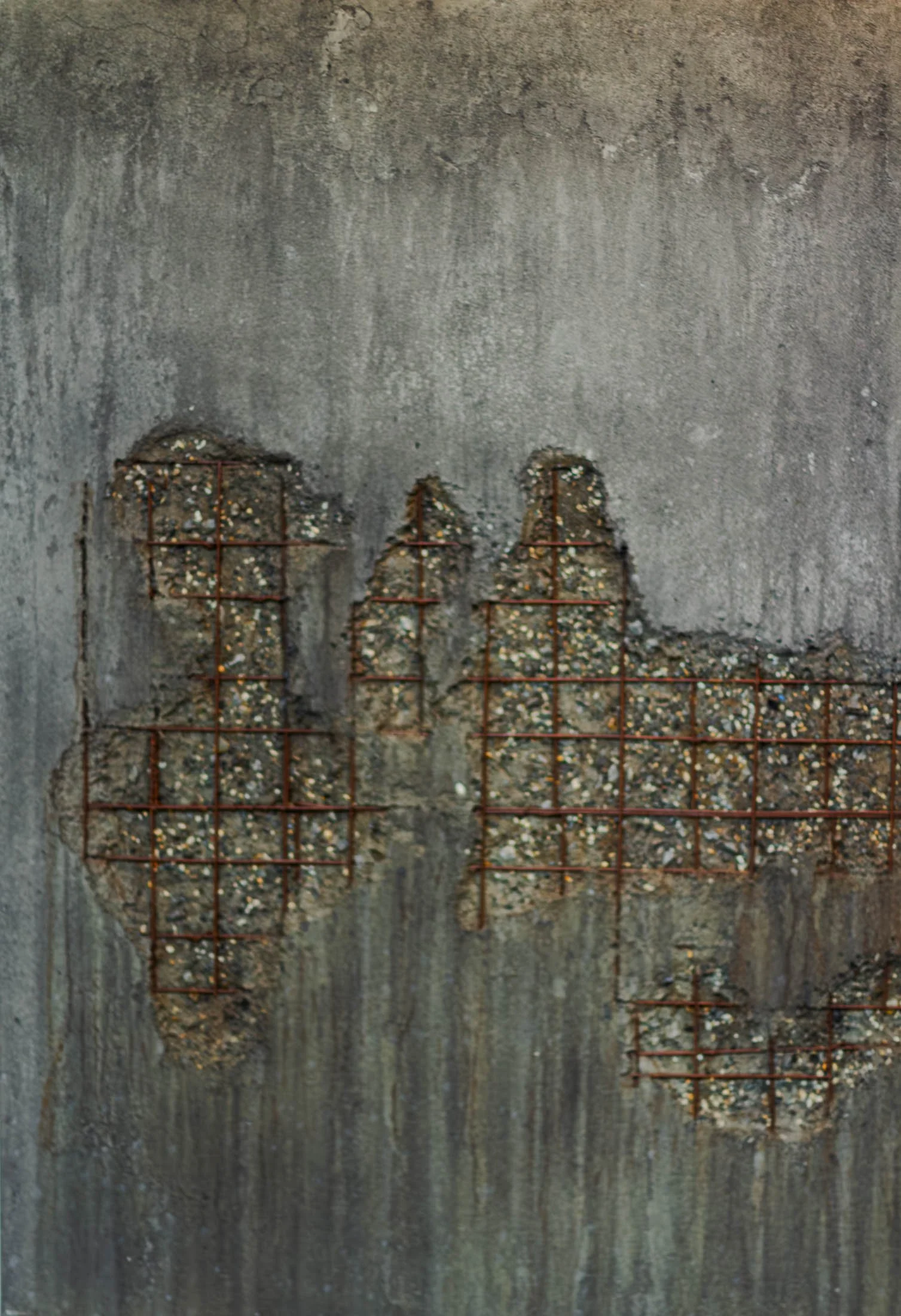Concrete wall artifact with exposed rusted steel grid and weathered mineral surface by The Concrete Anomaly.