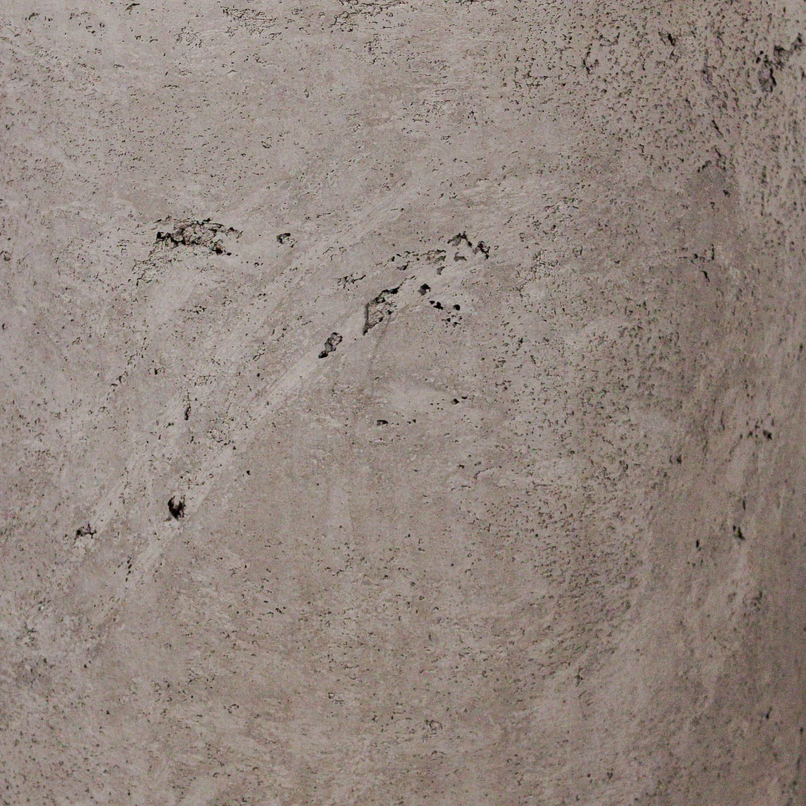 Mineral swirl detail within raw architectural concrete surface showing layered movement, exposed aggregate voids, and atmospheric tonal variation from the line RAW series by The Concrete Anomaly