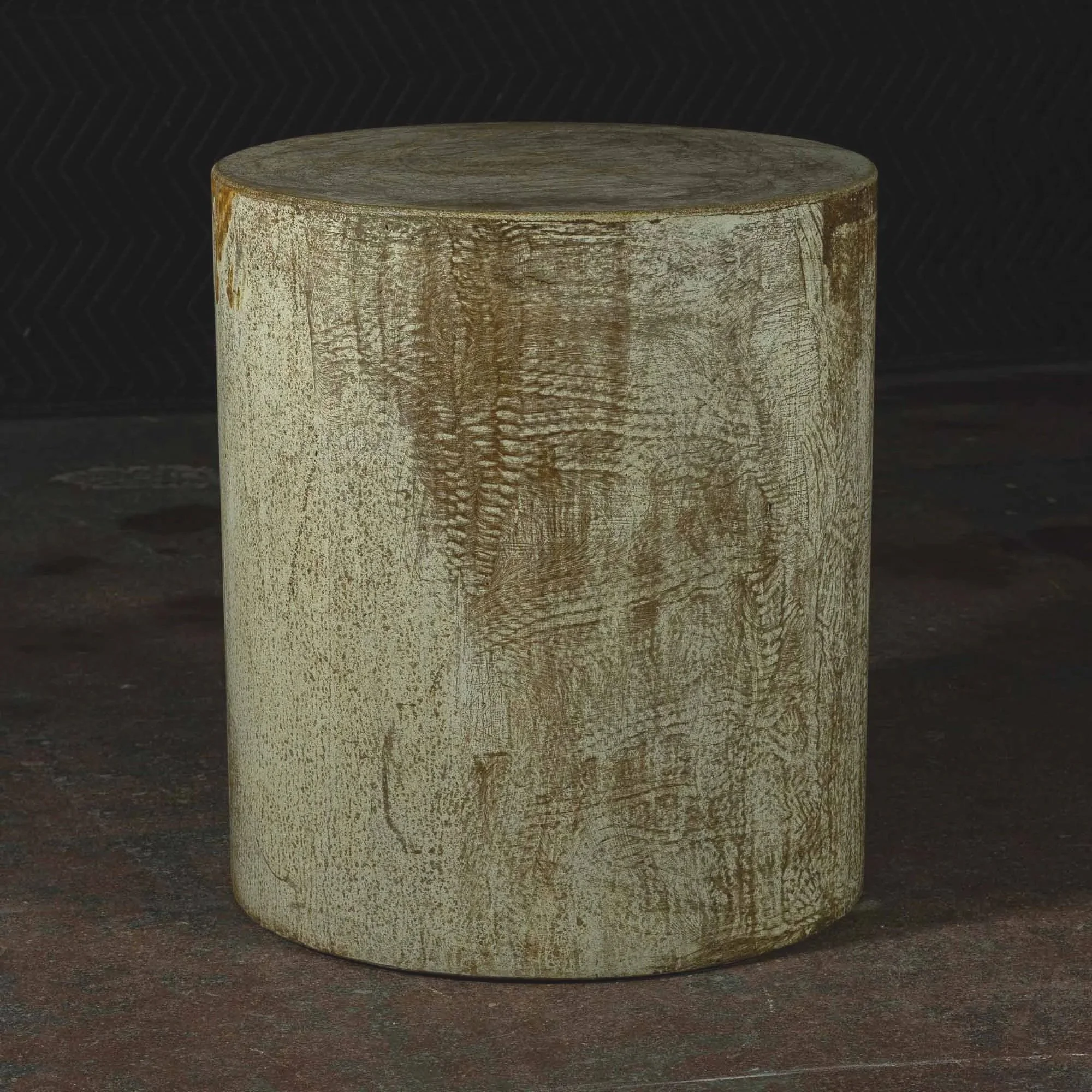 Distressed ochre concrete pedestal side table featuring aged mineral tones, textured surface variation, and sculptural monolithic form.