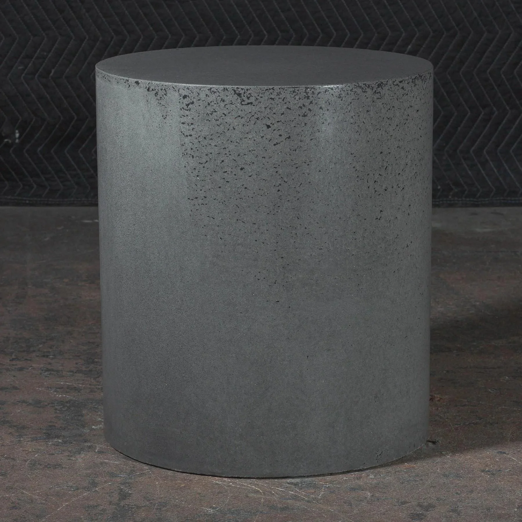 Minimal concrete side table from line ZERO 005 series with refined mineral grey surface and monolithic cylindrical form by Dylan Myers.