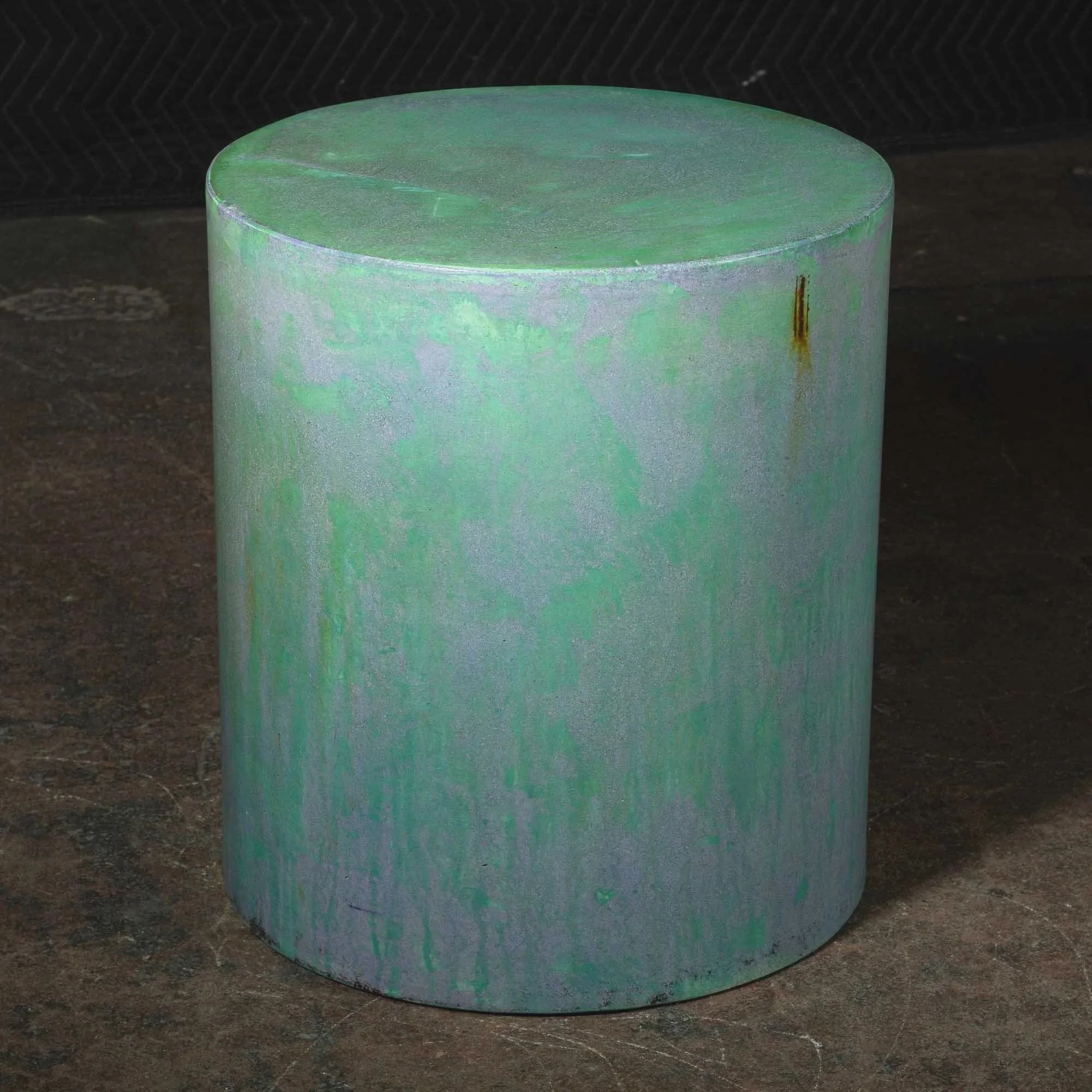 Sculptural concrete pedestal with evolving mineral patina and restrained surface variation inspired by oxidized industrial material systems.