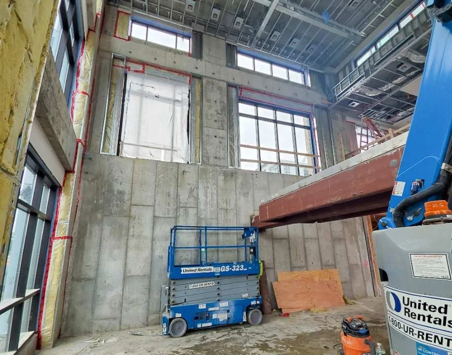 In-progress installation area for precast concrete wall panels prior to finish application and corner detailing.