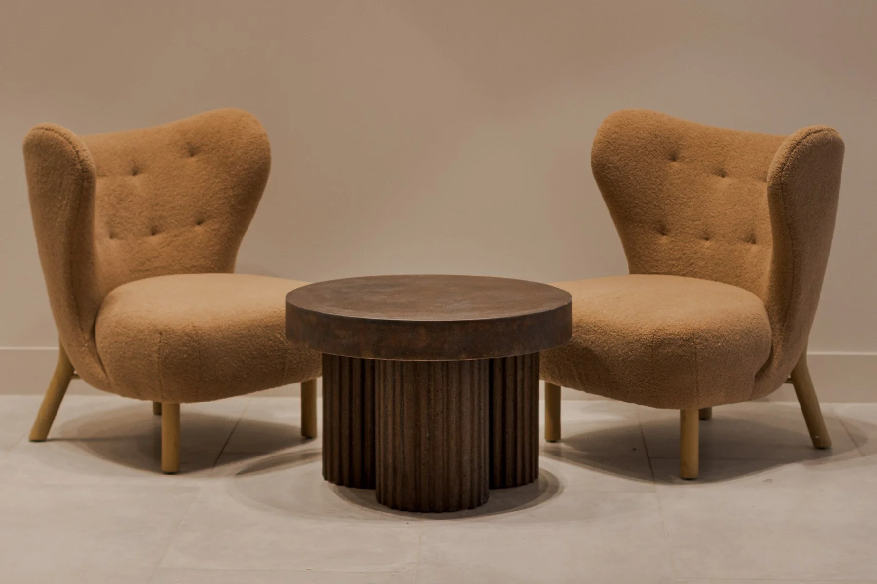 FLUTED | TOBACCO styled within a contemporary lounge environment as a collectible architectural concrete coffee table.