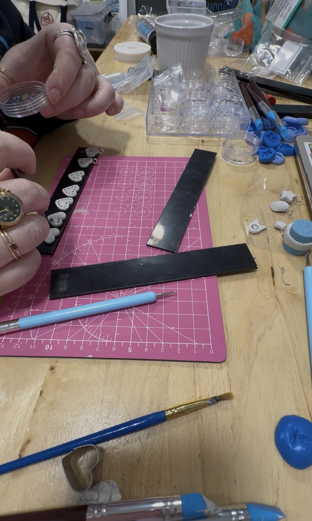 Picture of a person making silver clay heart pendants