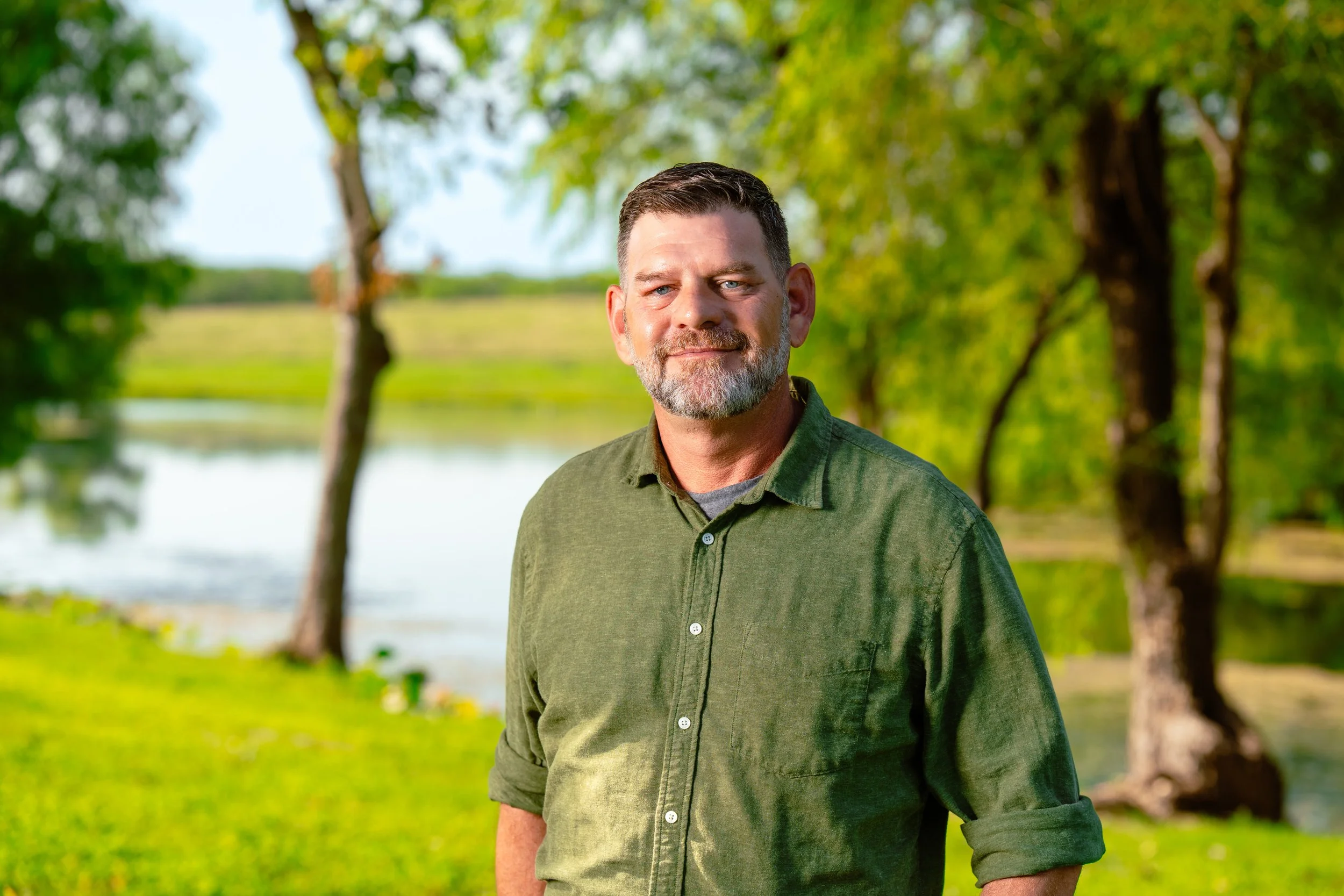 Tim Bodiford, Director of Plant Operations, by the lake at Plum Creek Recovery Ranch