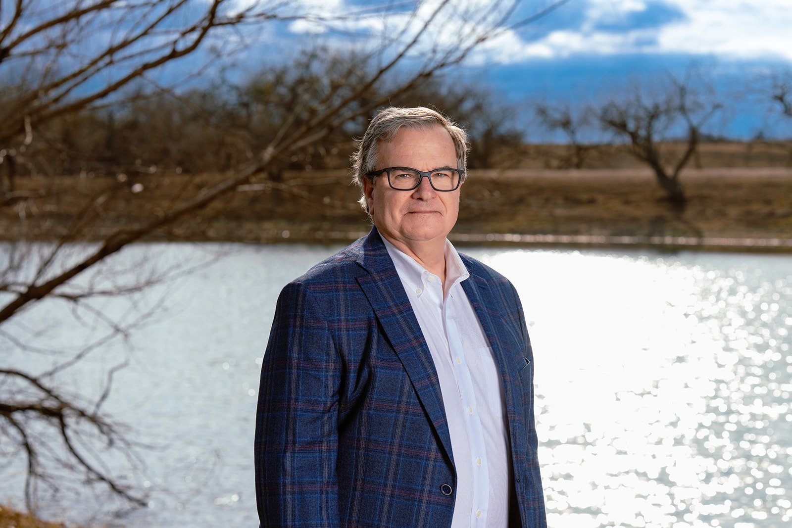 Chief Medical Officer & Co-Owner Tom Fowlkes, MD, by the pond at Plum Creek Recovery Ranch.