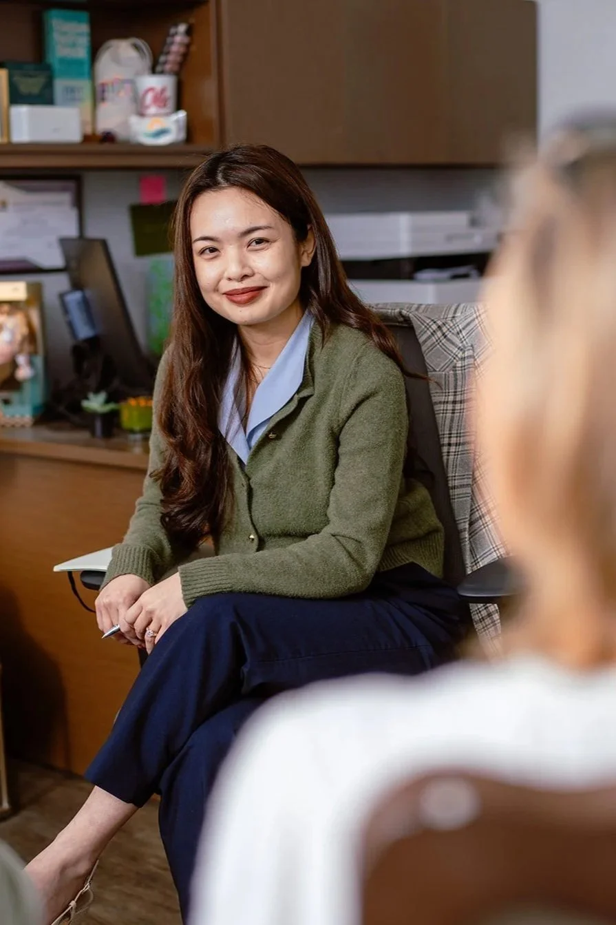 Julie Duong listening to a family