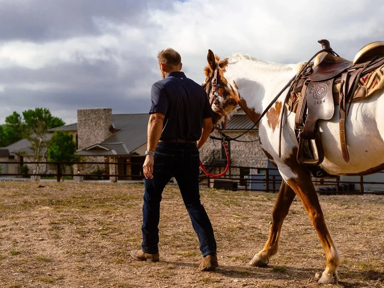Man and horse walking at Plum Creek Recovery Ranch