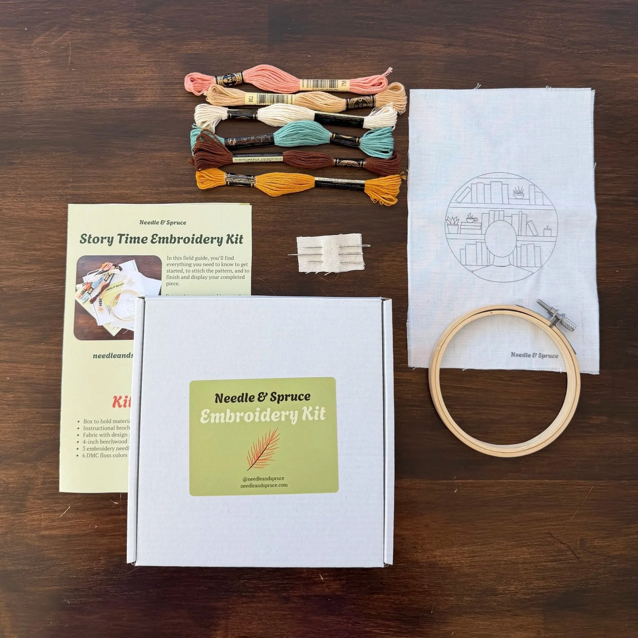 flat lay of embroidery kit including thread, instructions, and all components