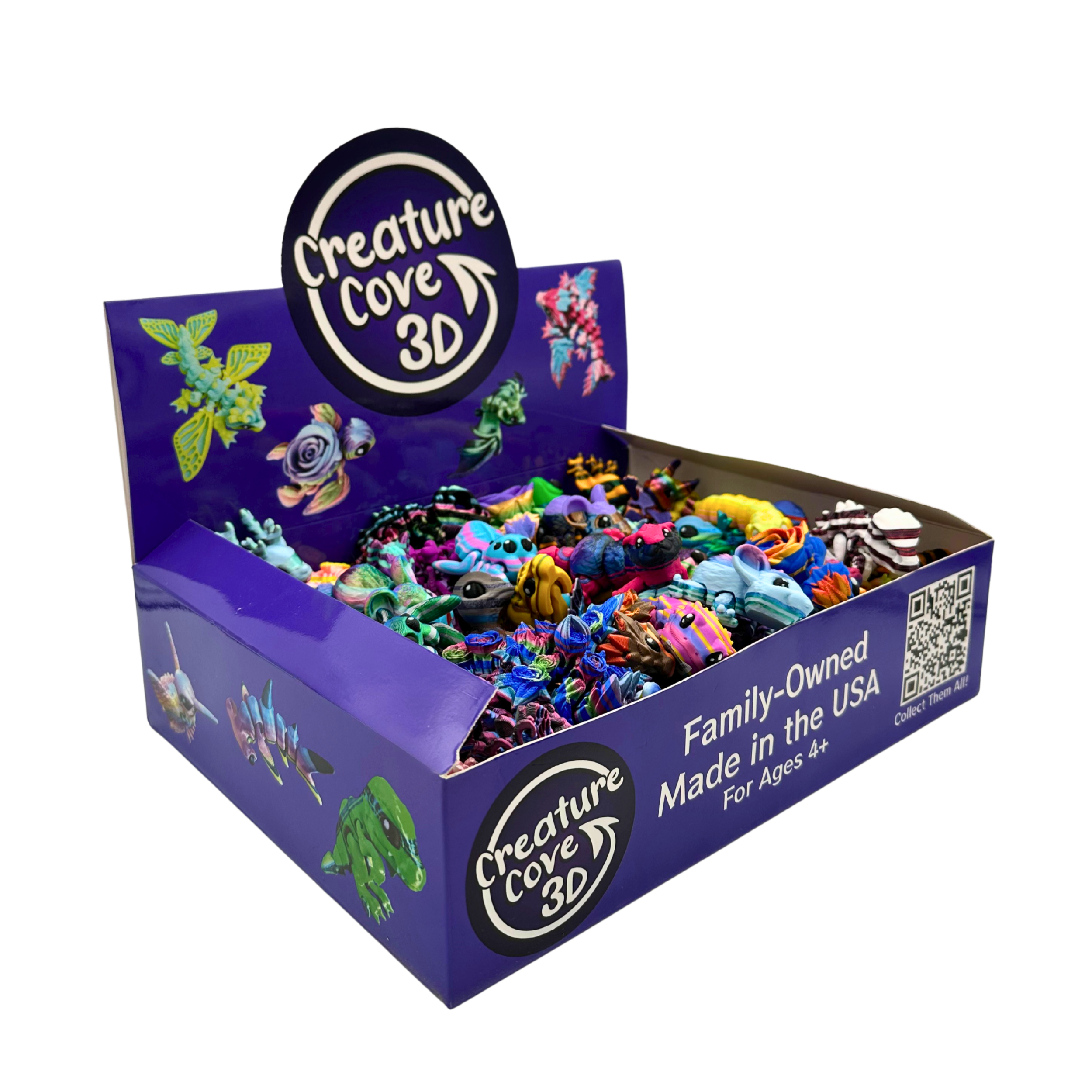 Open purple box labeled 'Creature Cove 3D' contains colorful 3D creature toys, with a circular label on the back that says 'Creature Cove 3D' and text indicating it is family-owned, made in the USA, and suitable for ages 4 and up.