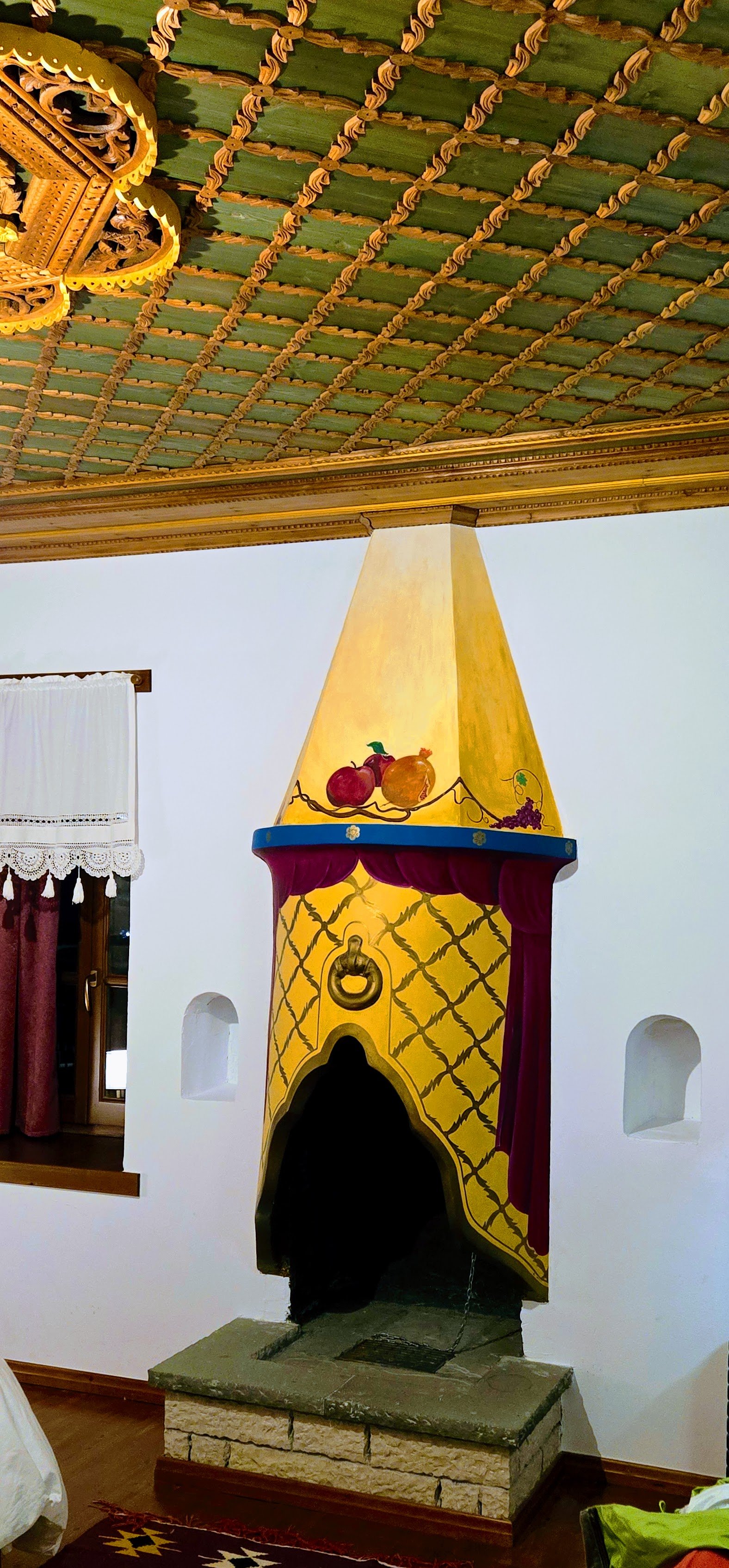 Hotel room of Kalemi Hotel featuring woodwork ceiling, a Ottoman designed fireplace.