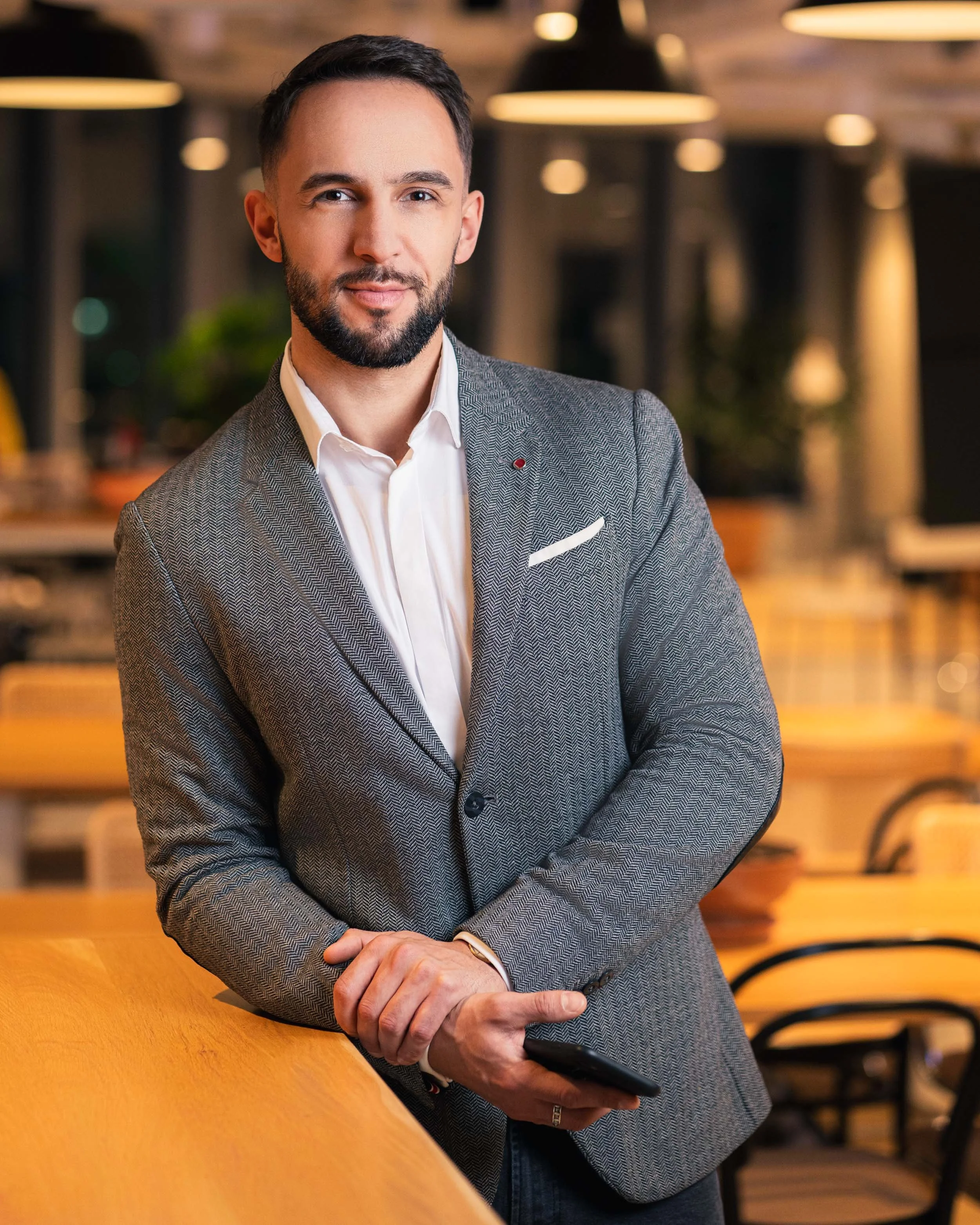 Business portrait of a professional in an office environment, captured in Warsaw, Poland