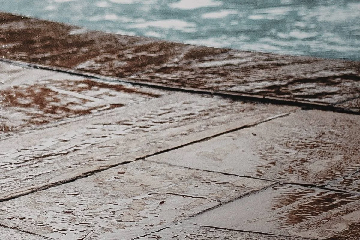 Wet patio surface showing moisture buildup that can make pool decks and outdoor areas slippery.