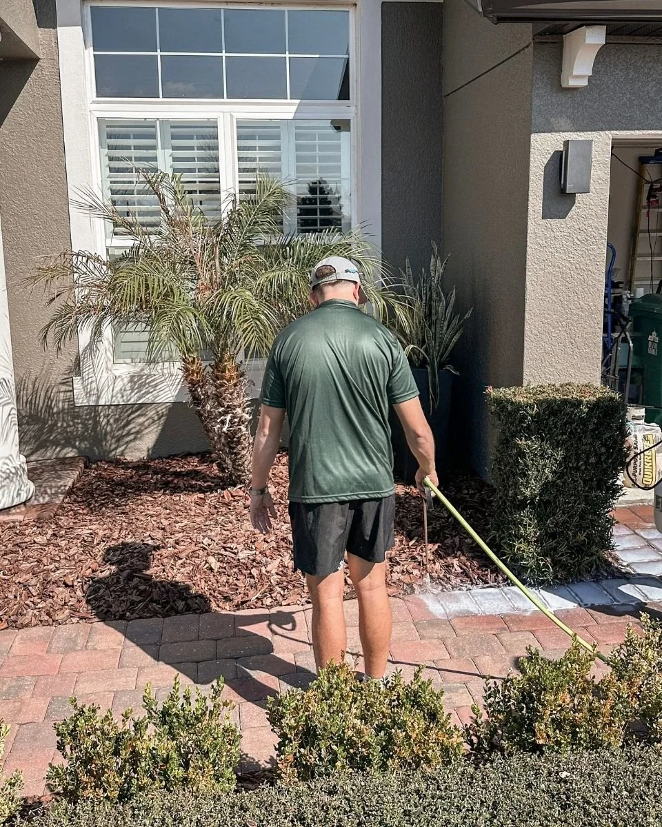 BravaSurface team member assessing a residential brick paver walkway in Broward County.