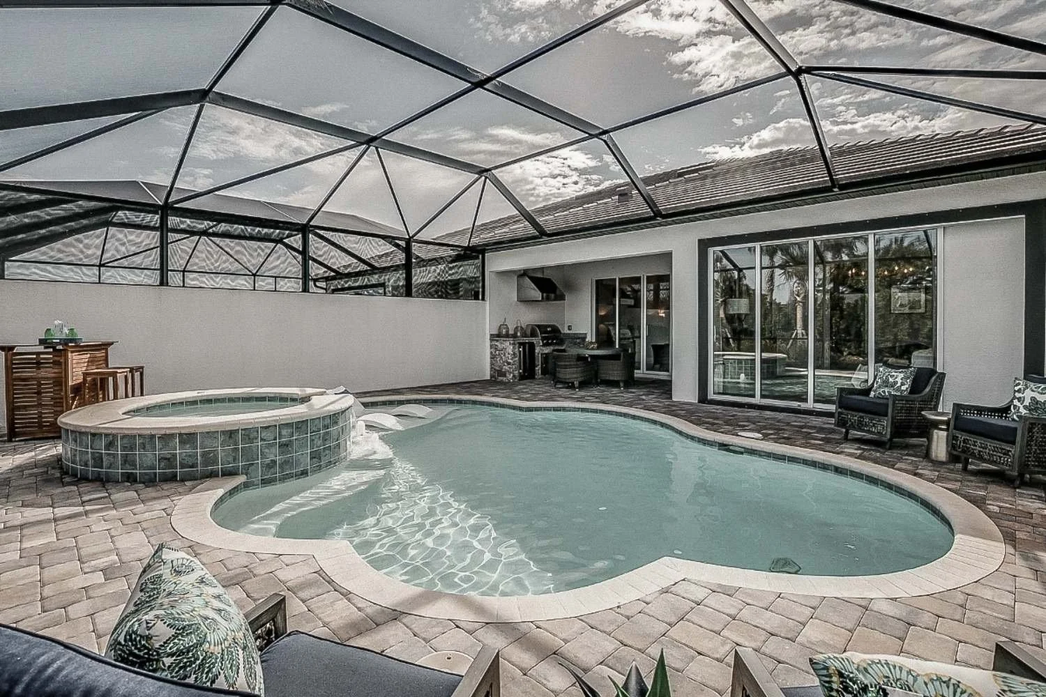 Screen enclosure and pool area connected to surrounding exterior cleaning surfaces in Broward County.