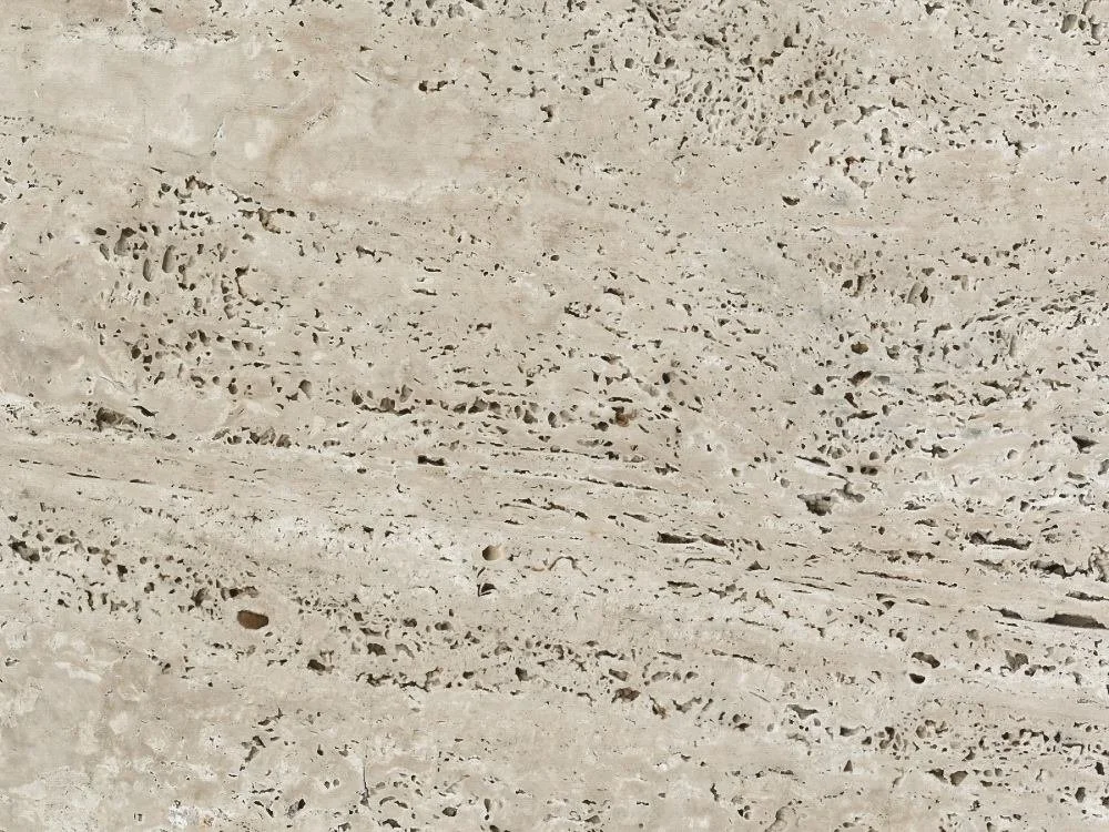 Close-up of travertine texture showing natural stone porosity and surface variation before sealing evaluation.