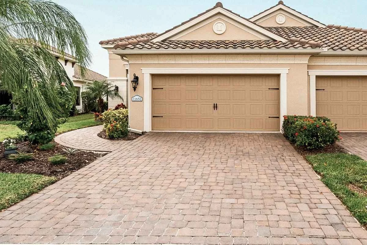 Residential paver driveway in Florida after professional cleaning and sealing treatment.