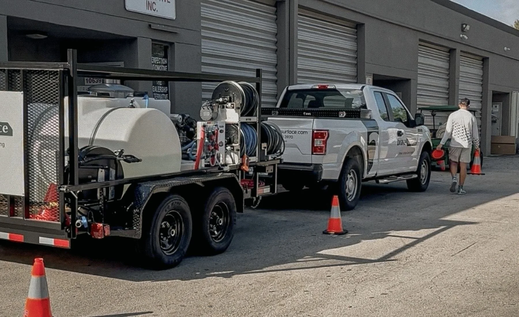 Commercial exterior cleaning setup with truck and trailer outside a Broward County commercial property.