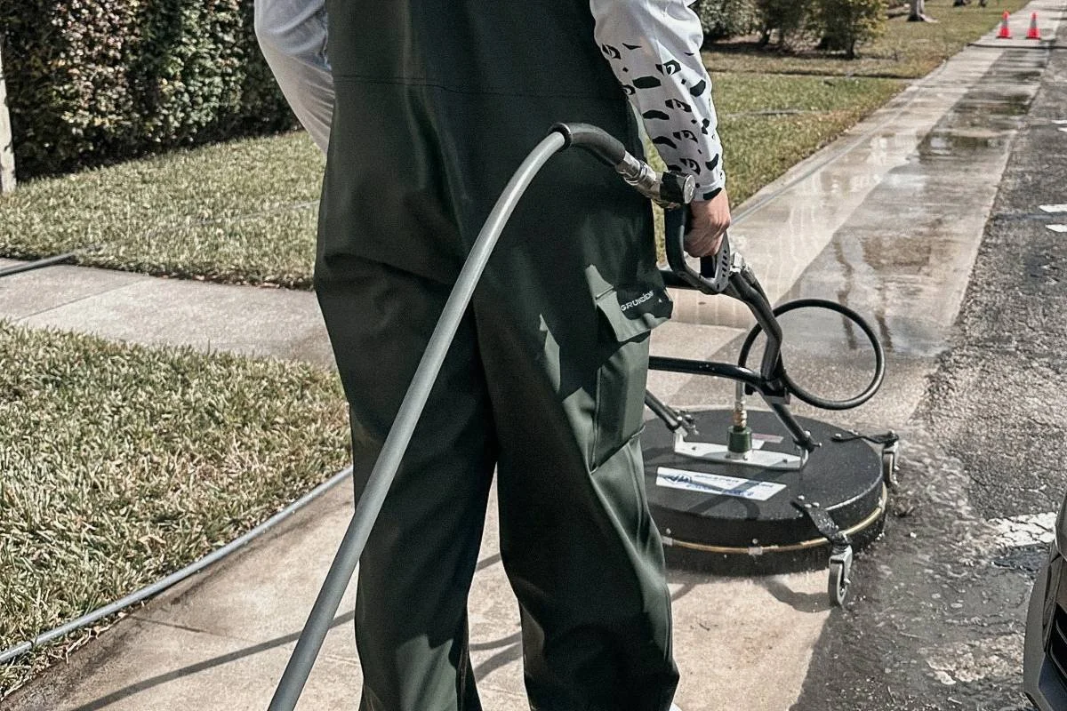 Professional exterior surface cleaning on a residential driveway and sidewalk in Broward County.