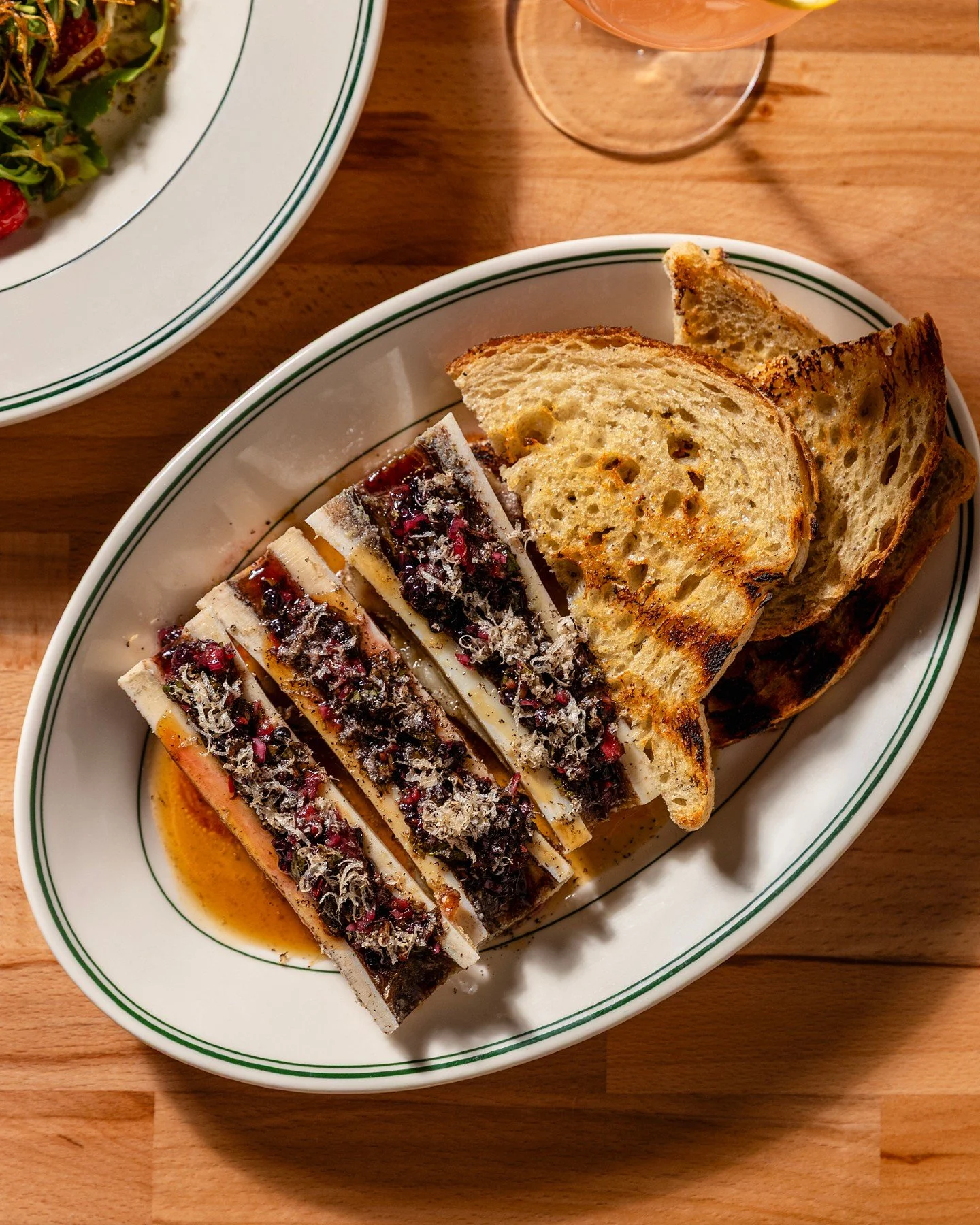 Spoonfuls of roasted marrow on grilled sourdough. This is the one you don't skip.

Rich and soft enough to spread, basically beef butter and we mean that as the highest compliment. A charred onion jus underneath goes smoky and a little sweet, blackbe