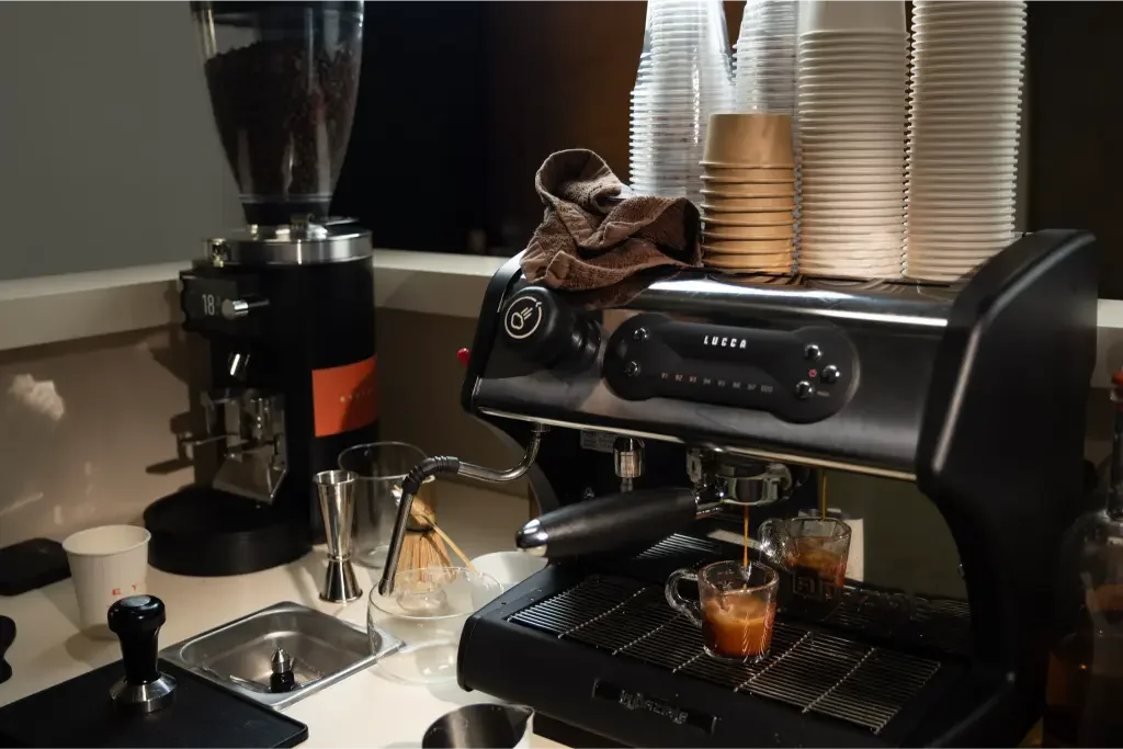 Eyevel barista crafting drinks behind the espresso bar