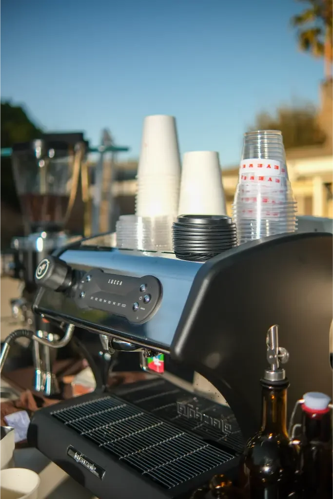 Commercial espresso machine topped with Eyevel-branded cups