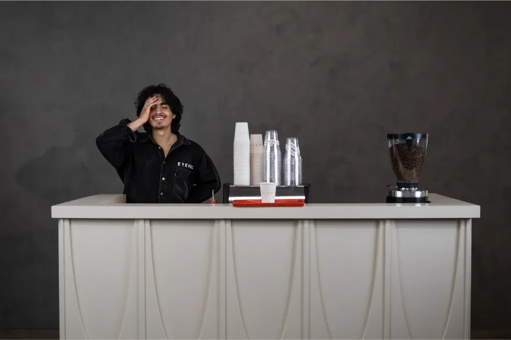 Eyevel barista crafting drinks at the espresso bar, photo 2