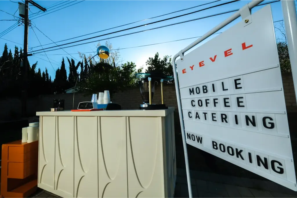The Eyevel midcentury coffee cart with its Now Booking letterboard