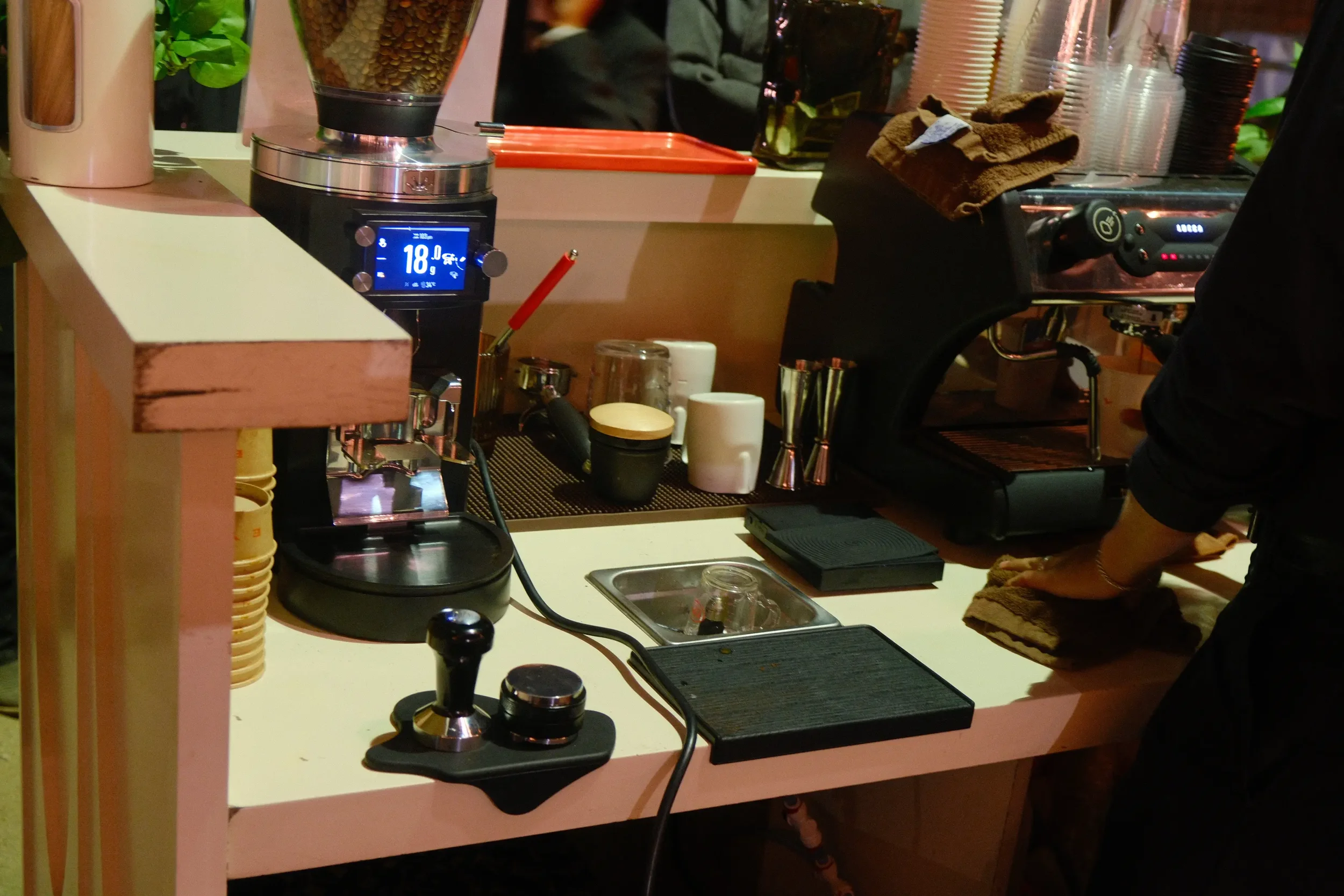 The barista workspace &mdash; grinder, tamper station, espresso machine