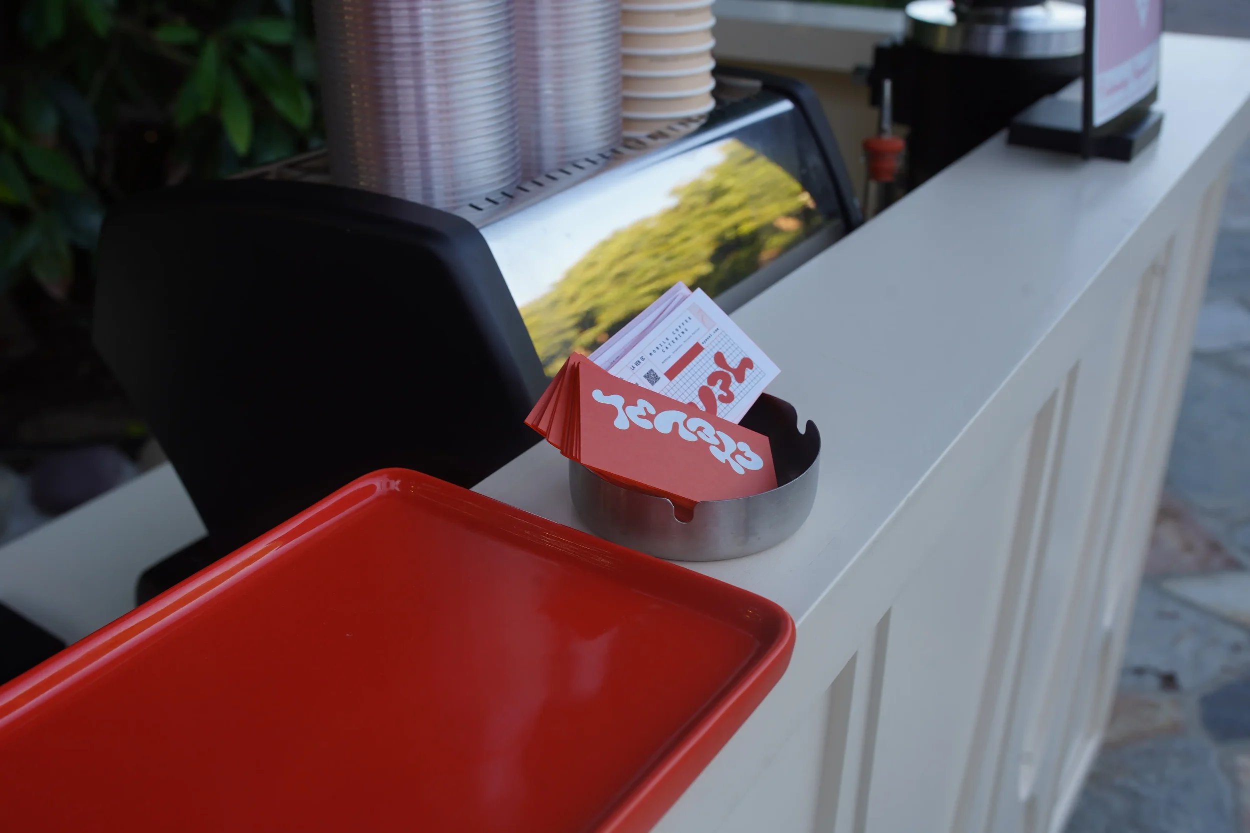 Sticker cups and the service tray staged on the bar