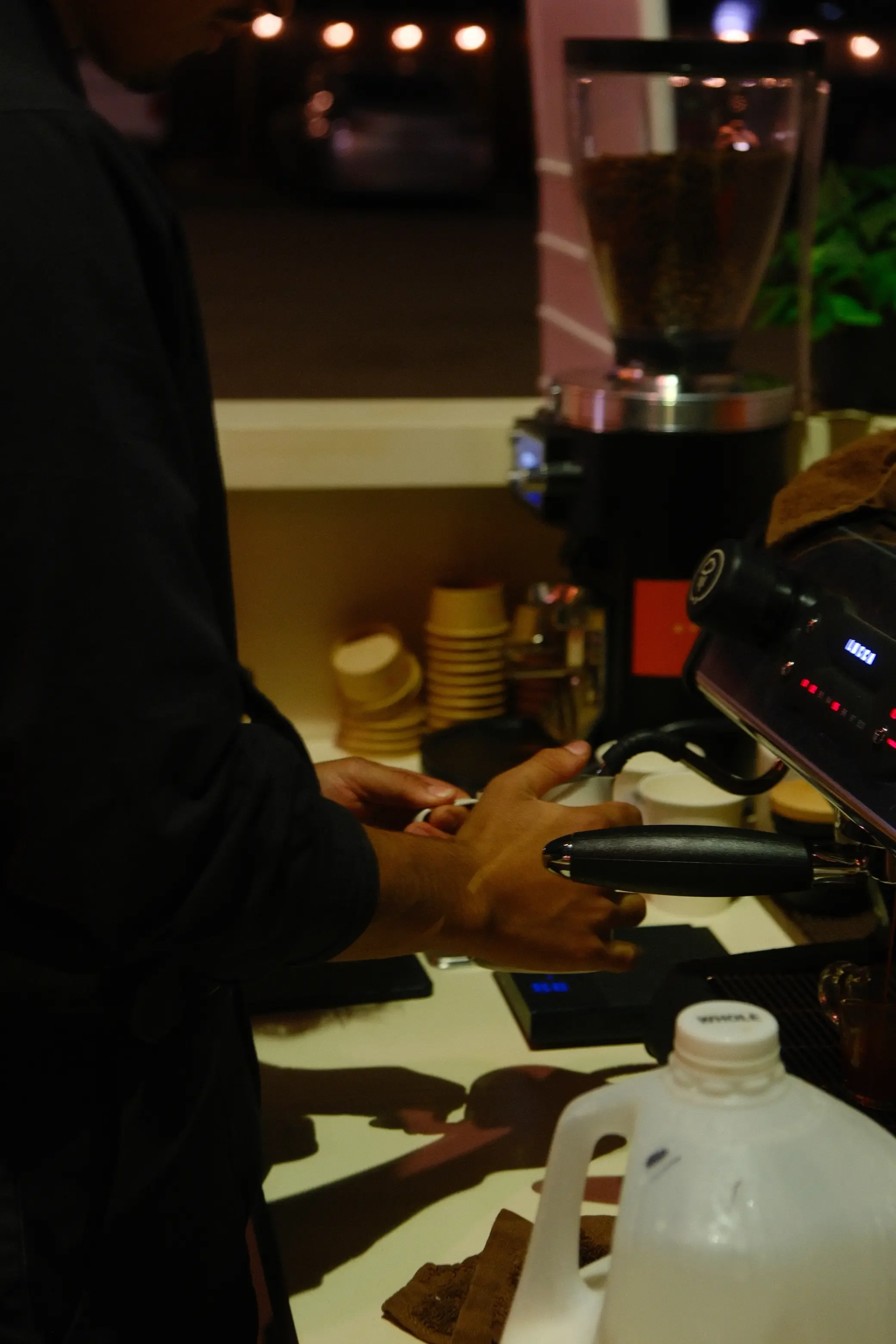 Eyevel barista crafting drinks behind the espresso bar