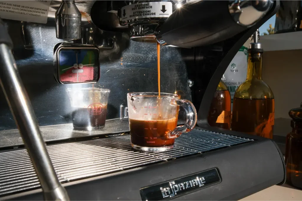 Eyevel barista crafting drinks behind the espresso bar