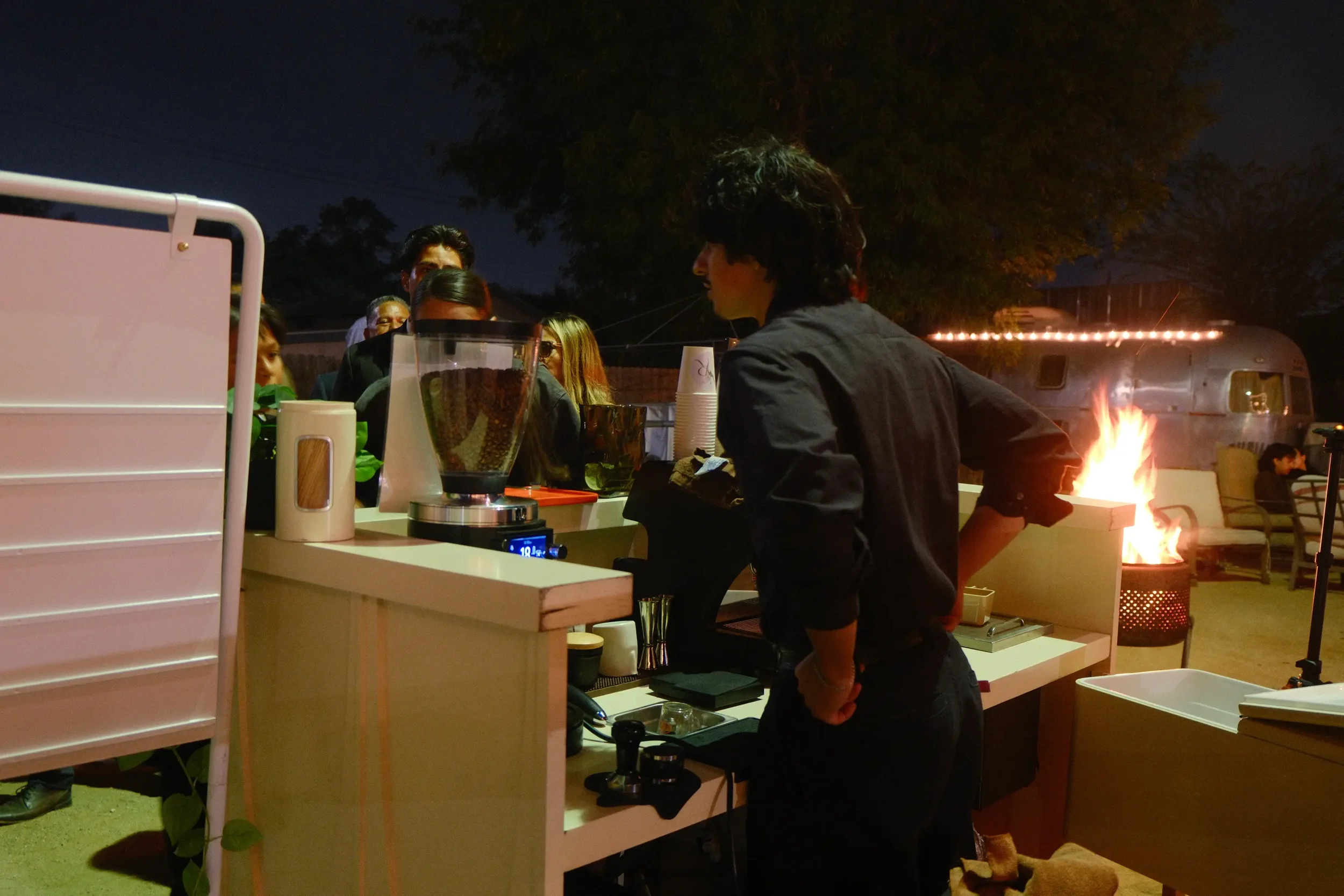 Eyevel barista crafting drinks behind the espresso bar