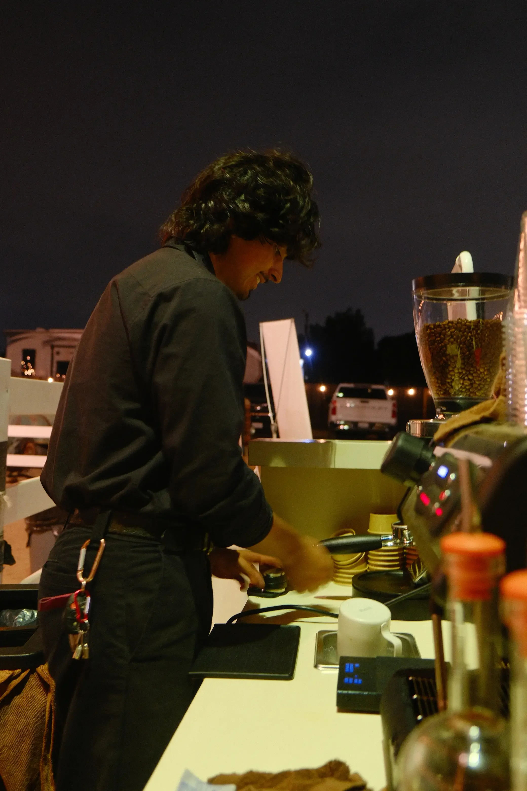 Eyevel barista crafting drinks behind the espresso bar